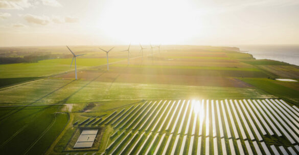Wind turbines and solar panels farm in a field. Renewable green