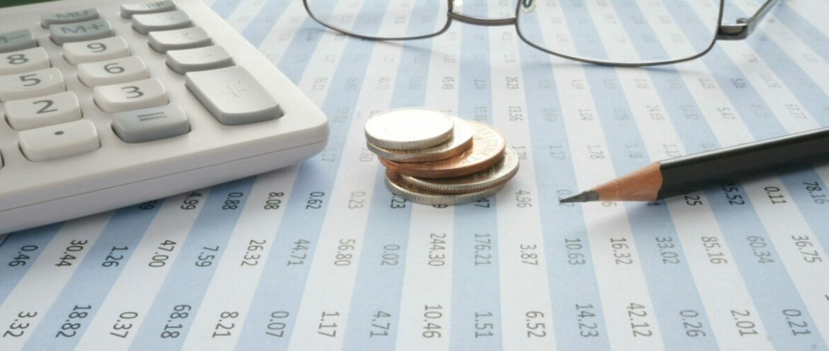 Spreadsheet with coins and calculator The curious case of cost stability