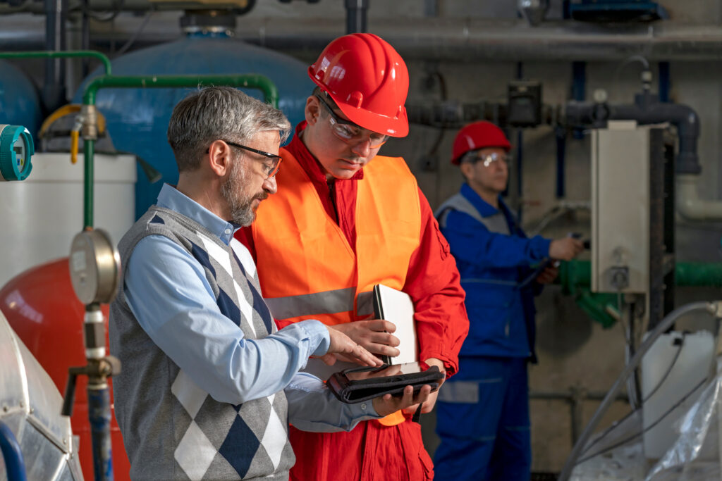 Technical,Manager,Using,Digital,Tablet,And,Discussing,About,Production,Process